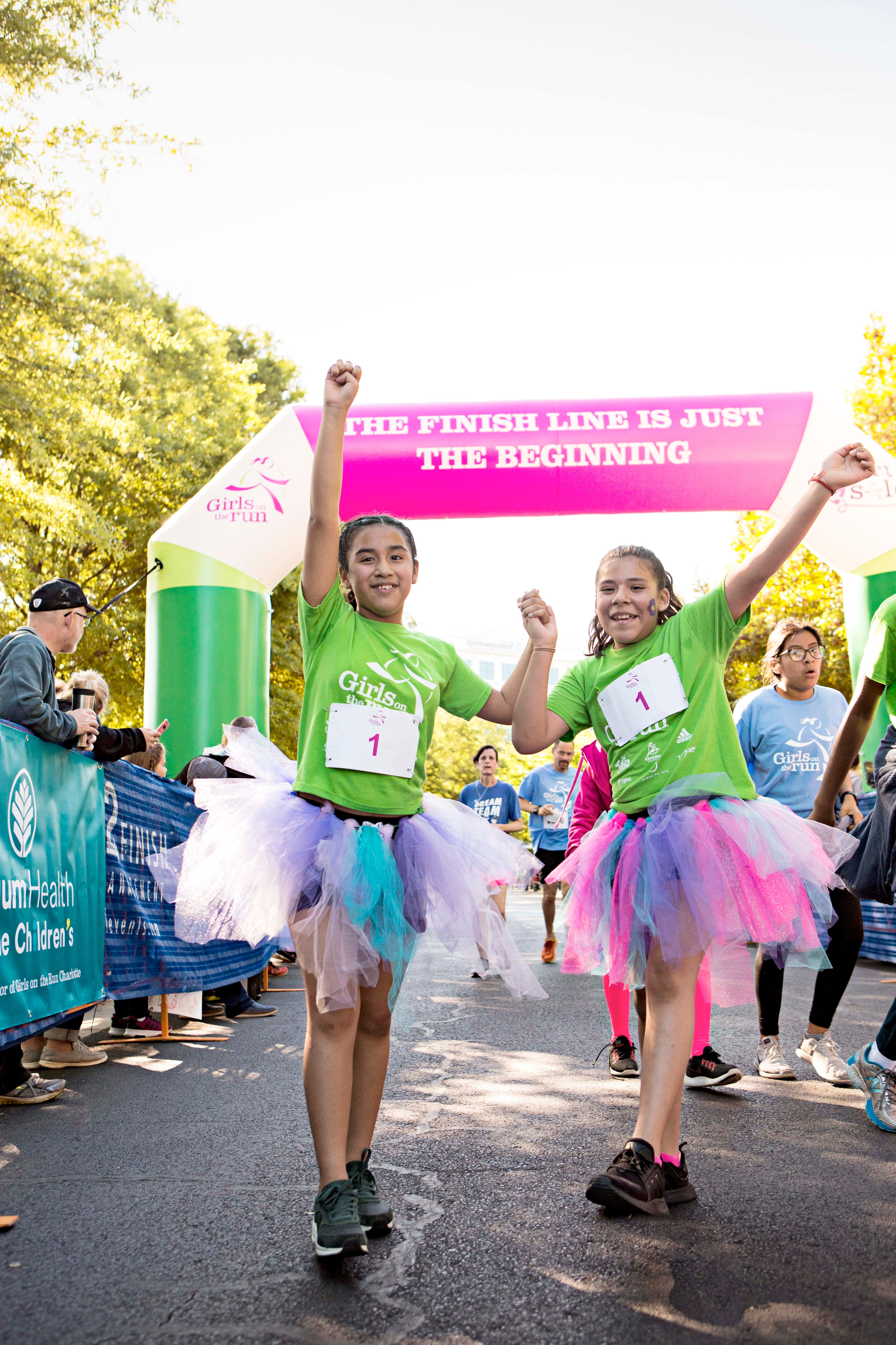 Two Girls on the Run participants celebrate at 5K finish line